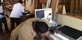 Ein Teilnehmer in Sambia baut mit den bereitgestellten Materialien einen Solarkoffer zusammen. Anschließend führt er didaktische Übungen durch, um die Technik für den Unterricht nutzbar zu machen.