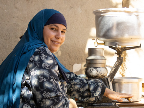 Das Bild zeigt eine Bäuerin bei der Produktion von Käse