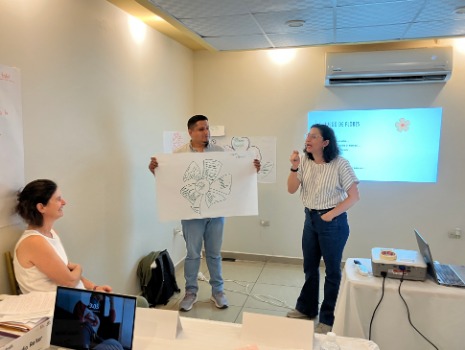 Das Bild zeigt zwei Workshopteilnehmer, die Ergebnisse einer Aufgabe präsentieren.